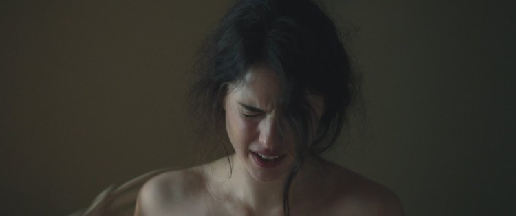 Margaret Kuelly sits on the face of Norman Ridus