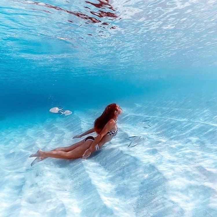 The girl is swimming in the sea