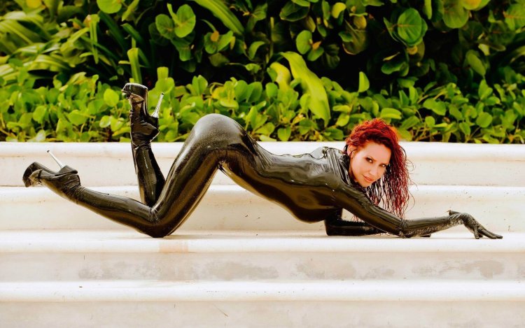 Girl in latex in the kitchen