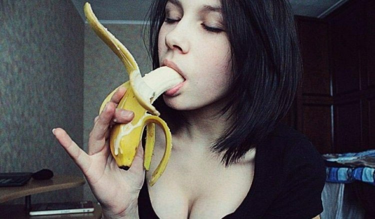 Girl with a banana in her mouth