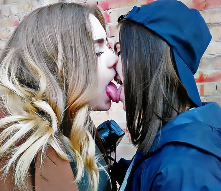 Two girls with a tongue