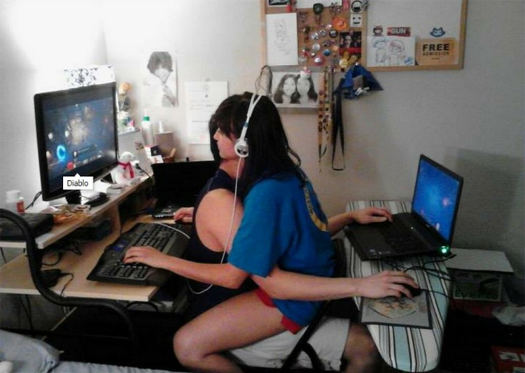 The guy is at the computer and the girl is on him
