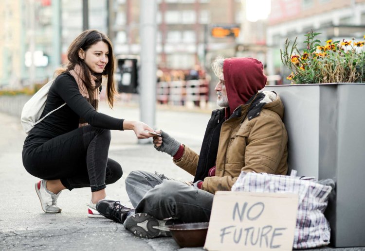 Girl gives money to a homeless