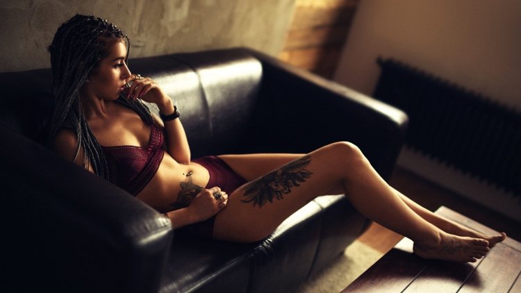 Girl with a tattoo on the couch