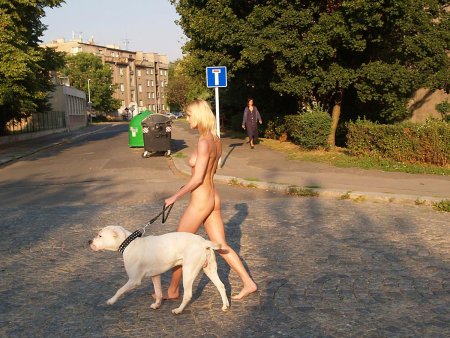 Girl walks with a dog nude