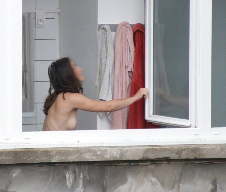 Girl topless on the balcony