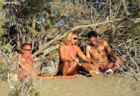 Swingers on a public beach