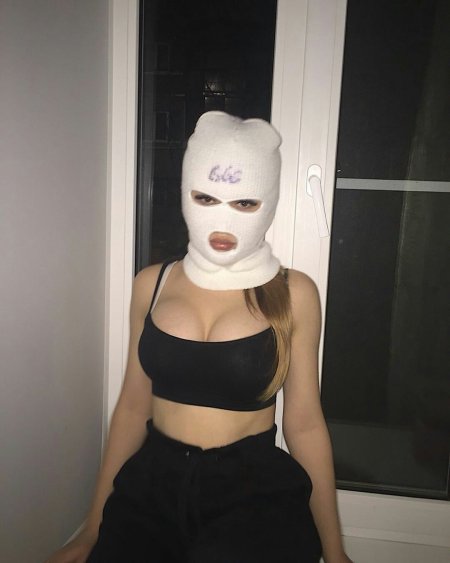 Girl in a mask shows her chest